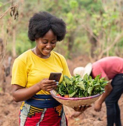 female african farmer making use of her phone