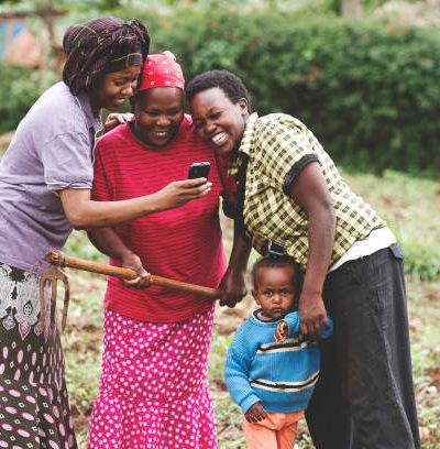 Three African farmers using a mobile application in Kiambu, Kenya. The image was taken in June 10, 2014.